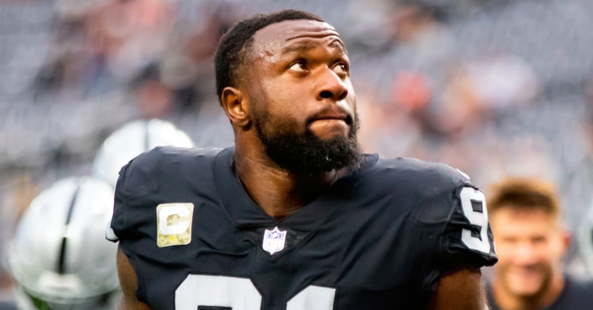 Raiders defensive end Yannick Ngakoue (91) confers with staff