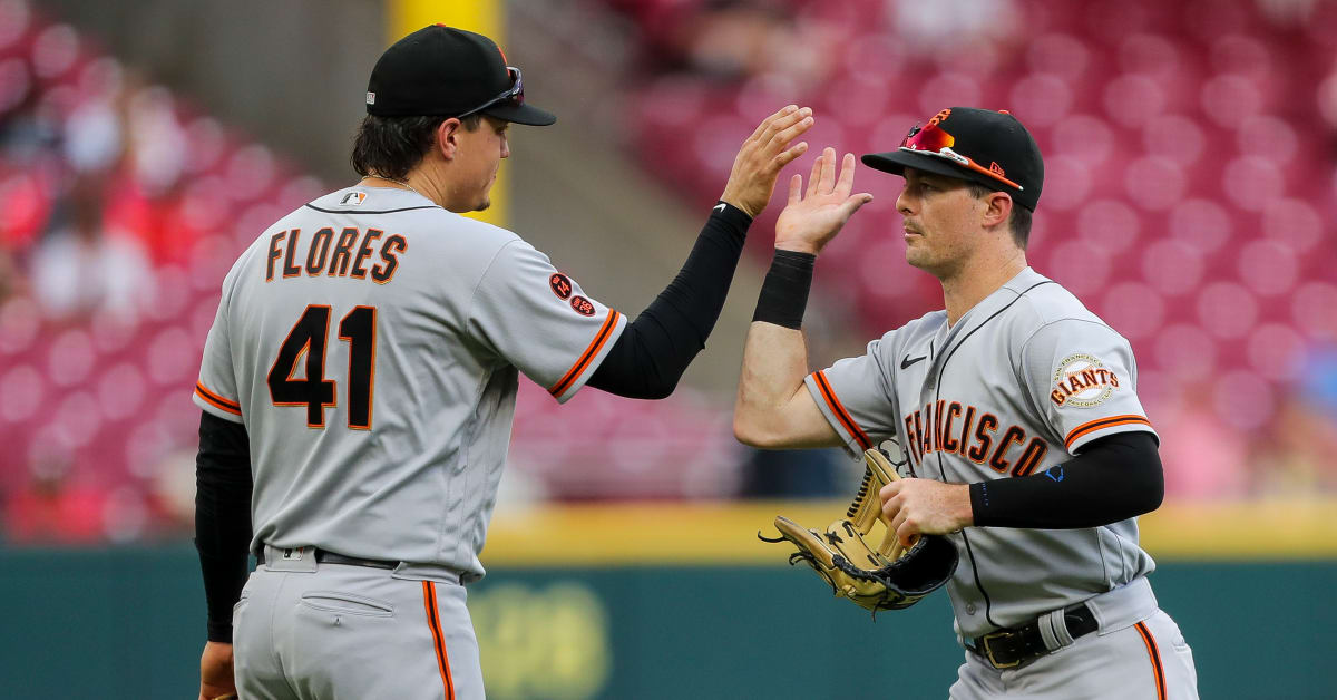 Wilmer Flores of the San Francisco Giants scores against catcher