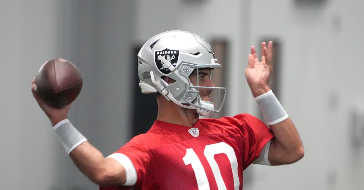 Jimmy Garoppolo, a 49ers quarterback, signs a football for a fan at their  training facility in