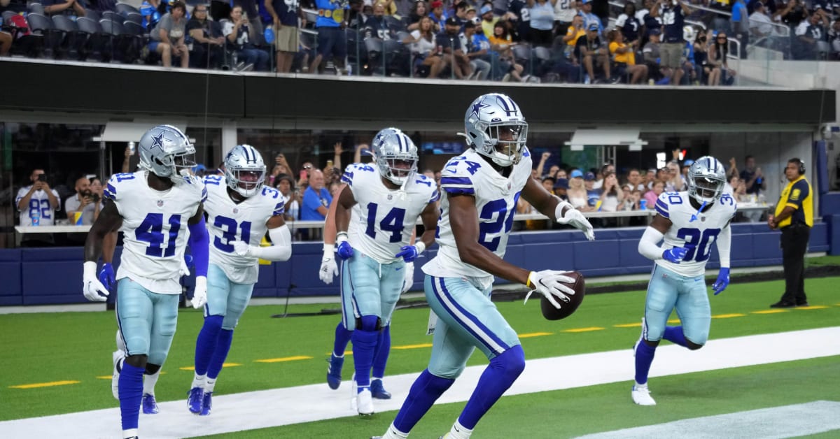 Dallas Cowboys' Nahshon Wright (25) defends as safety Markquese Bell (41)  gains yards after intercdepting a Seattle Seahawks pass in the second half  of a preseason NFL football game in Arlington, Texas