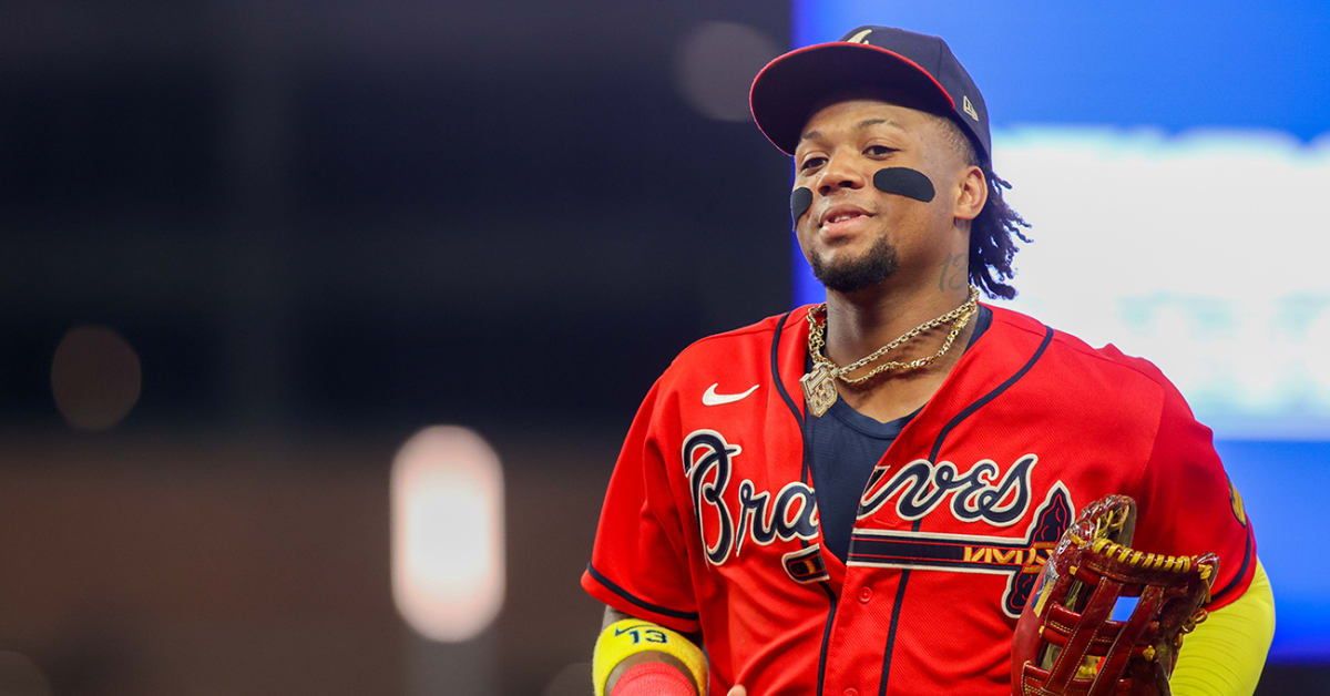 Ronald Acuña Jr. fends off fans on field during Braves-Rockies game