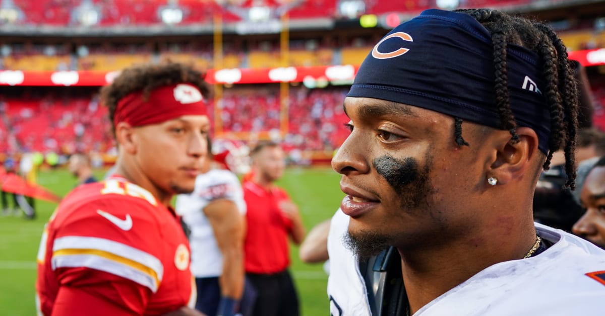 A Chicago Bears fan holds a quarterback Justin Fields jersey