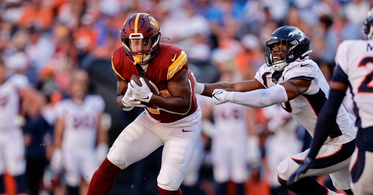 Washington Commanders running back Antonio Gibson (24) runs