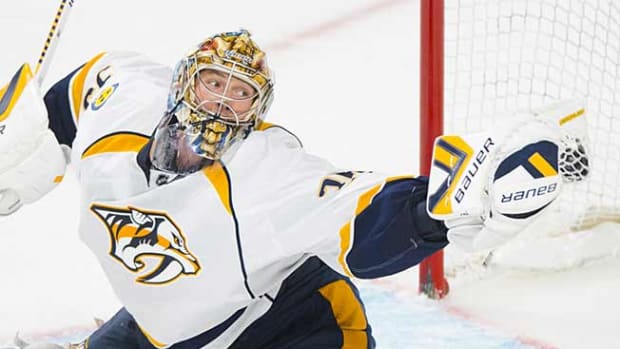 Predators' goalie Pekka Rinne gets tangled with his net ...