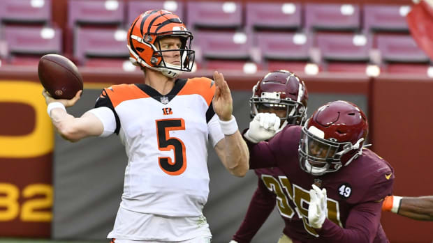 Nov 22, 2020; Landover, Maryland, USA; Cincinnati Bengals quarterback Ryan Finley (5) attempts a pass as Washington Football Team outside linebacker Shaun Dion Hamilton (51) pressures during the second half at FedExField. Mandatory Credit: Brad Mills-USA TODAY Sports