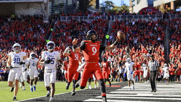 Nov 6, 2021; Cincinnati, Ohio, USA; Cincinnati Bearcats quarterback Desmond Ridder (9) runs with the ball for a touchdown against the Tulsa Golden Hurricane in the first half at Nippert Stadium. Mandatory Credit: Aaron Doster-USA TODAY Sports