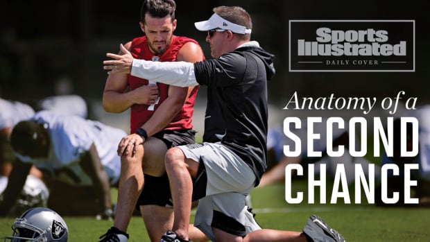 Raiders coach Josh McDaniels talks to Derek Carr at OTAs.