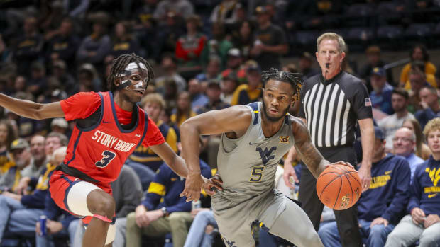 Dec 22, 2022; Morgantown, West Virginia, USA; West Virginia Mountaineers guard Joe Toussaint (5) drives past Stony Brook Seawolves guard Toby Onyekonwu (3) during the second half at WVU Coliseum.