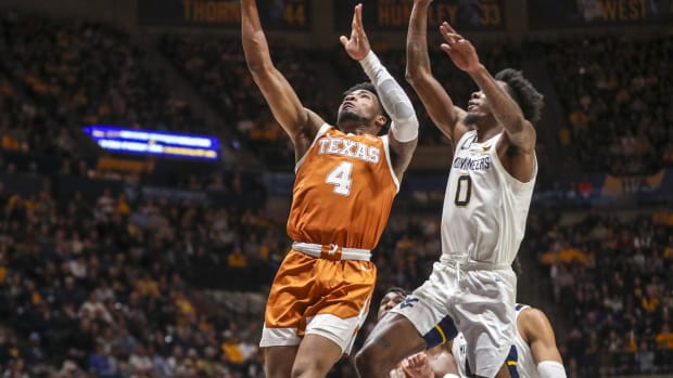 Jan 21, 2023; Morgantown, West Virginia, USA; Texas Longhorns guard Tyrese Hunter (4) shoots in the lane against West Virginia Mountaineers guard Kedrian Johnson (0) during the first half at WVU Coliseum.