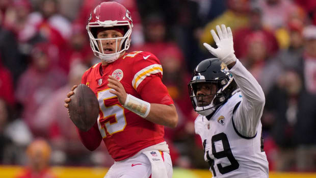 Chiefs quarterback Patrick Mahomes (15) works under pressure as Jaguars defensive end Arden Key attempts to sack him.