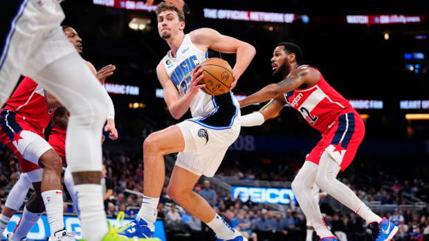 Orlando Magic draft picks forward Caleb Houstan (2) and forward Paolo  Banchero (5) show off their new jerseys during a news conference for the NBA  basketball team, Friday, June 24, 2022, in