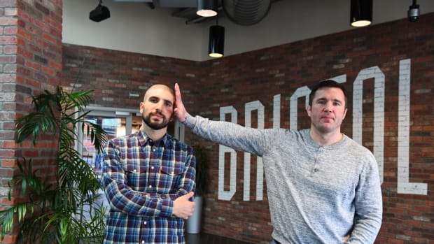 Chael Sonnen & Ariel Helwani pose for the ESPN camera.