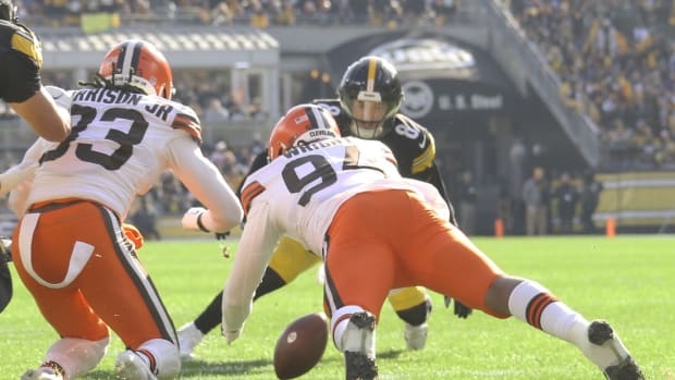 Pittsburgh Steelers quarterback Kenny Pickett (8) looks to pass while  pressured by Cleveland Browns defensive end Alex Wright (94) during the  first half of an NFL football game in Pittsburgh, Sunday, Jan.