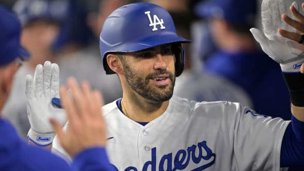 Dodgers designated hitter J.D. Martinez gets high fives in the dugout
