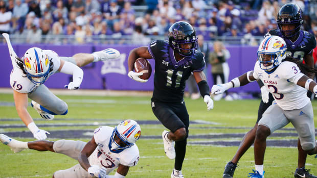 Nov 20, 2021; Fort Worth, Texas, USA; TCU Horned Frogs wide receiver Derius Davis carries the ball a 43-yard touchdown as he runs by Kansas Jayhawks linebacker Gavin Potter (19), cornerback Ra'Mello Dotson (13) and safety Ricky Thomas Jr. (3) during the first half at Amon G. Carter Stadium.