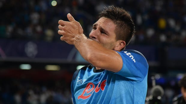 Giovanni Simeone pictured kissing a tattoo of the Champions League logo on his left arm after scoring for Napoli against Liverpool in his first-ever game in the competition in September 2022