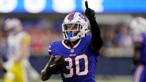 Bills cornerback Dane Jackson runs back with an intercepted pass during the first half of an NFL football game against the Los Angeles Rams.