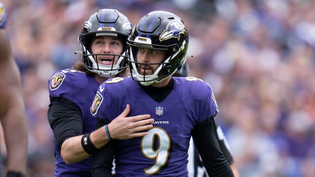 Baltimore Ravens kicker Justin Tucker (9), with Jordan Stout