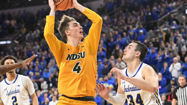 Mar 8, 2022; Sioux Falls, SD, USA; North Dakota State Bison forward Grant Nelson (4) drives against South Dakota State Jackrabbits guard Alex Arians (34) in the second half at Denny Sanford Premier Center.