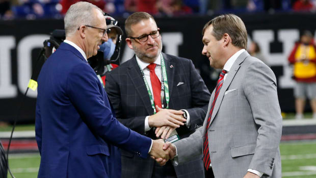 SEC Commissioner Greg Sankey shakes hands with Georgia coach Kirby Smart at Lucas Oil Stadium before the College Football Playoff National Championship game in Indianapolis, on Monday, Jan. 10, 2022.
