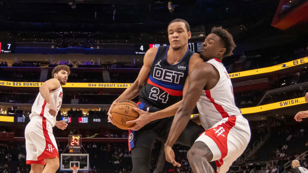 Jan 12, 2024; Detroit, Michigan, USA; Detroit Pistons forward Kevin Knox II (24) battles for the ball with Houston Rockets forward Jae'Sean Tate (8) during the in the first half at Little Caesars Arena. Mandatory Credit: David Reginek-USA TODAY Sports