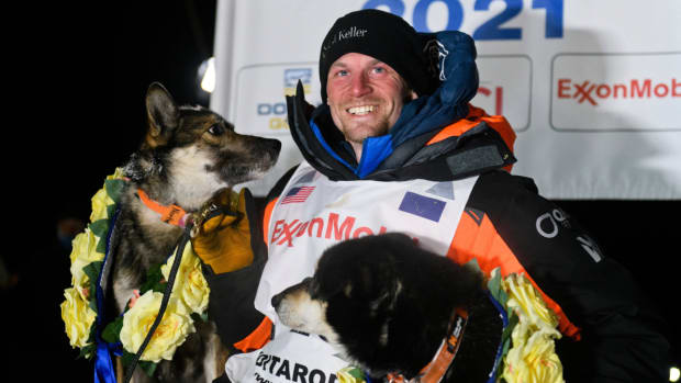 Iditarod musher Dallas Seavey poses with his dogs North and Gamble.