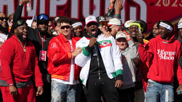 Kansas City Chiefs defensive tackle Chris Jones (95) addresses the crowd on stage with quarterback Patrick Mahomes (15) during the celebration of the Kansas City Chiefs winning Super Bowl LVII.