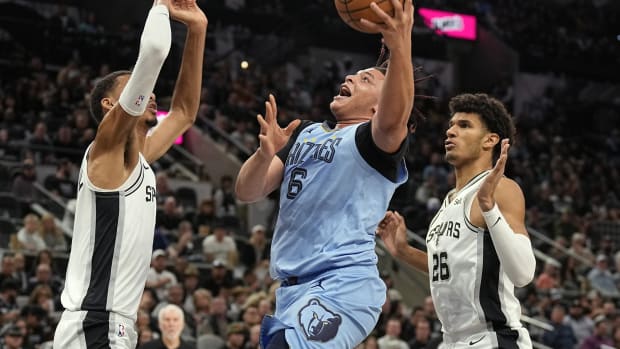 Nov 18, 2023; San Antonio, Texas, USA; Memphis Grizzlies forward Kenneth Lofton Jr. (6) drives to the basket between San Antonio Spurs forwards Victor Wembanyama (1) and Dom Barlow (26) during the second half at Frost Bank Center.