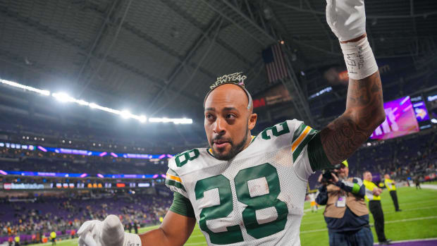 Dec 31, 2023; Minneapolis, Minnesota, USA; Green Bay Packers running back AJ Dillon (28) celebrates with fans wearing a Happy New Year headband after the game against the Minnesota Vikings at U.S. Bank Stadium.
