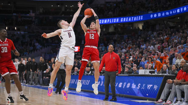 Michael O'Connell hits a buzzer-beating three-pointer over Isaac McKneely to tie the game at the end of regulation of the Virginia men's basketball game against NC State in the semifinals of the 2024 ACC Men's Basketball Tournament at Capital One Arena.