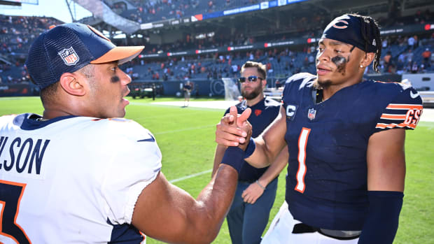 Chicago Bears quarterback Justin Fields (1), right, meets with Denver Broncos quarterback Russell Wilson (3) at midfield after their game at Soldier Field.