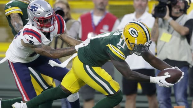 ASHWAUBENON, WI - AUGUST 05: Green Bay Packers wide receiver Allen Lazard  (13) grabs his helmet during Green Bay Packers Family Night at Lambeau  Field, on August 5, 2022 in Green Bay