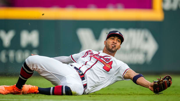 Aug 22, 2023; Cumberland, Georgia, USA; Atlanta Braves left fielder Eddie Rosario (8) makes a sliding catch on a ball hit by New York Mets shortstop Francisco Lindor (12) (not shown) during the first inning at Truist Park.