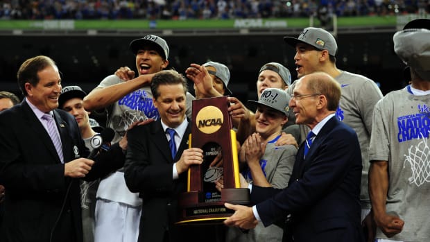 Apr 2, 2012; New Orleans, LA, USA; Kentucky Wildcats head coach John Calipari (middle) is presented with the NCAA national championship trophy after the finals of the 2012 NCAA men's basketball Final Four against the Kansas Jayhawks at the Mercedes-Benz Superdome. Kentucky won 67-59. Mandatory Credit: Bob Donnan-USA TODAY Sports