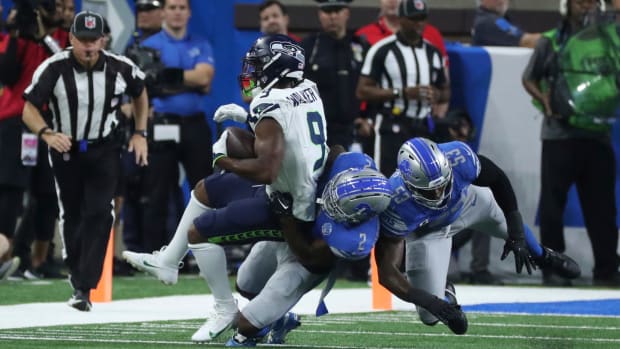 Detroit Lions safety C.J. Gardner-Johnson (2) tackles Seattle Seahawks running back Kenneth Walker III during the first half at Ford Field, Sunday, Sept. 17, 2023. Defensive end Charles Harris (53) also helps out on the play.