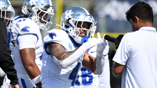 Sep 23, 2023; Nashville, Tennessee, USA; Kentucky Wildcats running back JuTahn McClain (4) celebrates after a touchdown against the Vanderbilt Commodores during the first half at FirstBank Stadium. Mandatory Credit: Christopher Hanewinckel-USA TODAY Sports