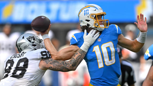 Raiders safety Trevon Moehrig (25) adjusts his head wrap during their NFL  training camp practic …