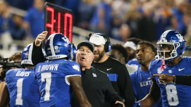 After scoring a touchdown catch, Kentucky Wildcats wide receiver Barion Brown (7) gets congratulated by UK head coach Mark Stoops in the first half against Tennessee Saturday in Lexington. Oct. 28, 2023.