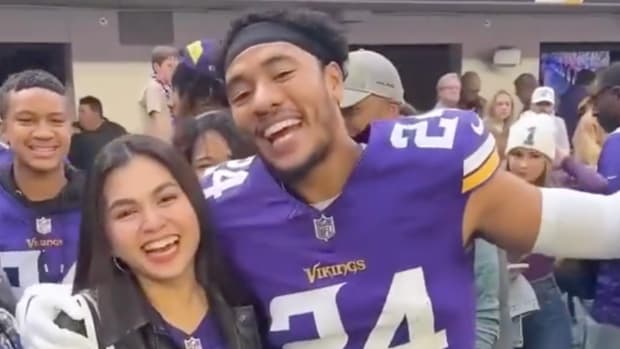 Vikings defensive back Camryn Bynum poses with his wife Lalaine before a game.