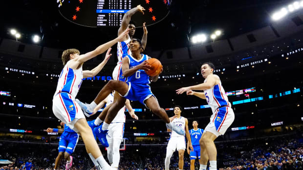 Nov 14, 2023; Chicago, Illinois, USA; Kansas Jayhawks guard Johnny Furphy (10) defends Kentucky Wildcats guard Rob Dillingham (0) during the first half at United Center. Mandatory Credit: David Banks-USA TODAY Sports