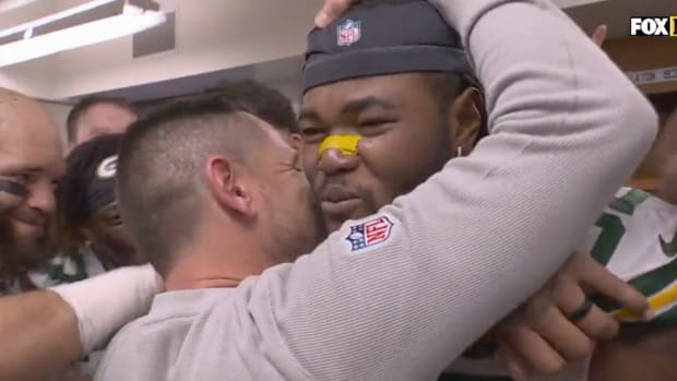 Packers coach Matt LeFleur hugs linebacker Rashan Gary after giving him the game ball.