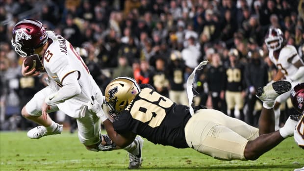 Nov 11, 2023; West Lafayette, Indiana, USA; Purdue Boilermakers defensive lineman Joe Anderson (95) tackles Minnesota Golden Gophers quarterback Athan Kaliakmanis (8) during the second half at Ross-Ade Stadium.