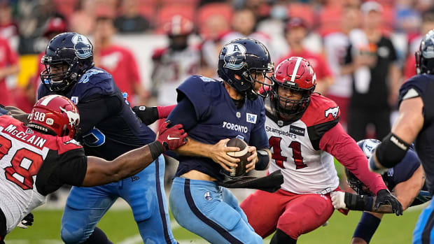 Aug 20, 2022; Toronto, Ontario, CAN; Calgary Stampeders defensive lineman Terrell McClain (98) and Mike Rose (41) close in before sacking Toronto Argonauts quarterback McLeod Bethel Thompson (4) during the first half at BMO Field. Mandatory Credit: John E. Sokolowski-USA TODAY Sports  