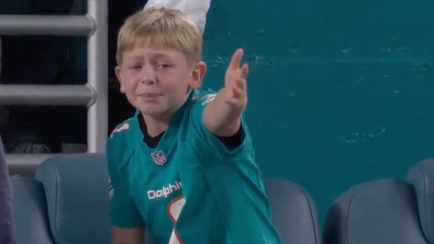 A Dolphins fan reacts after a penalty.