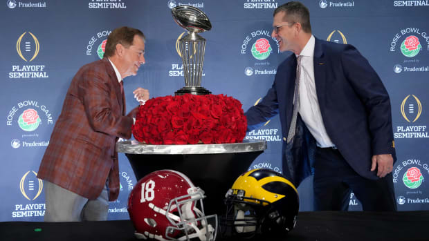 Alabama Crimson Tide head coach Nick Saban and Michigan Wolverines head coach Jim Harbaugh shake hands at the Rose Bowl coaches press conference.