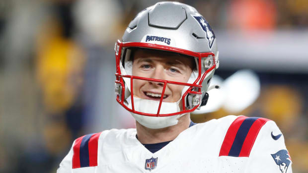 New England Patriots quarterback Mac Jones smiles during warm ups before the game against the Pittsburgh Steelers at Acrisure Stadium.