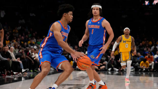 Dec 19, 2023; Charlotte, North Carolina, USA; Florida Gators guard Zyon Pullin (0) handles the ball watched by guard Walter Clayton Jr. (1) during the second half against the Michigan Wolverines at Spectrum Center. Mandatory Credit: Jim Dedmon-USA TODAY Sports