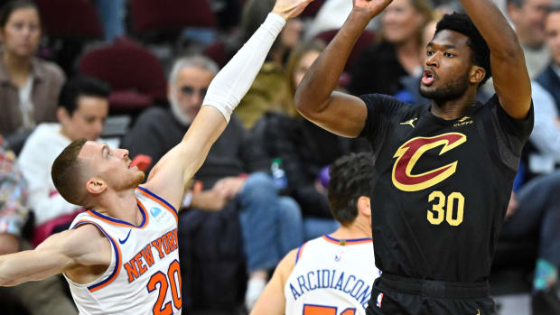 Oct 31, 2023; Cleveland, Ohio, USA; Cleveland Cavaliers center Damian Jones (30) shoots beside New York Knicks guard Dylan Windler (20) in the fourth quarter at Rocket Mortgage FieldHouse.