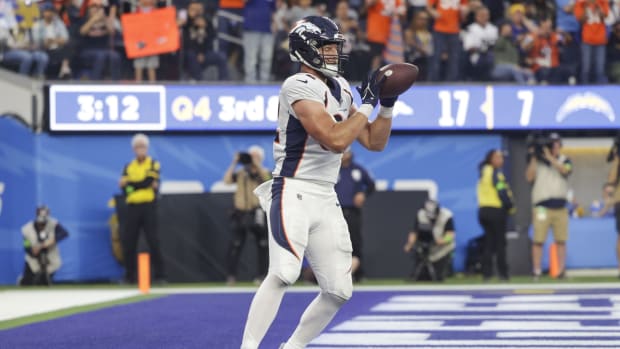 Dec 10, 2023; Inglewood, California, USA; Denver Broncos tight end Adam Trautman (82) scores a touchdown during the second half in a game against the Los Angeles Chargers at SoFi Stadium. Mandatory Credit: Yannick Peterhans-USA TODAY Sports  