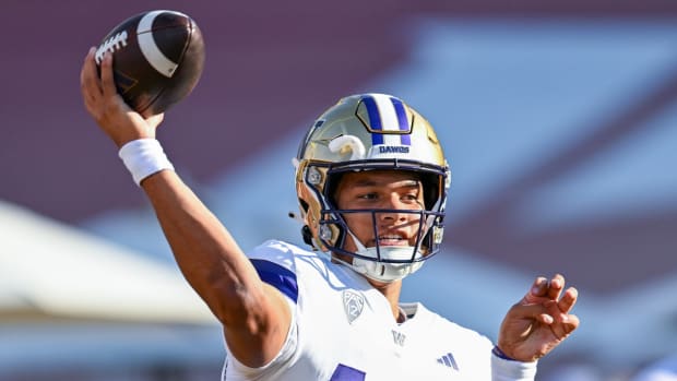 Washington quarterback Austin Mack warms up before a game.